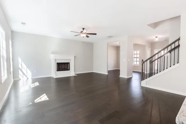 a view of a livingroom with wooden floor and a fireplace