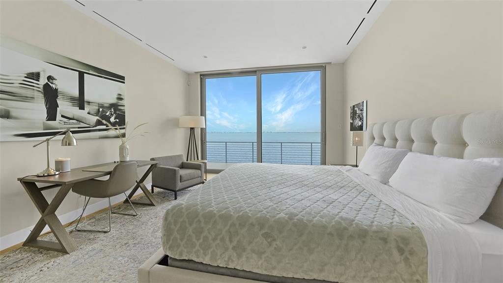 4123 Bay Shore Road Sarasota, FL 34234 - Photo 14 of 29 a bedroom with a bed and chair