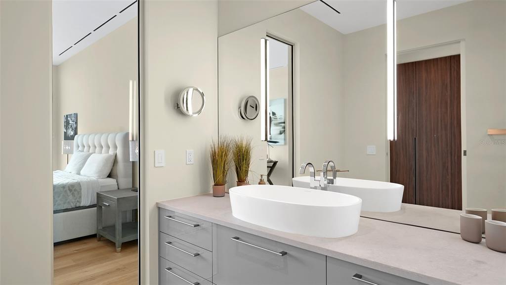 4123 Bay Shore Road Sarasota, FL 34234 - Photo 15 of 29 a bathroom with a double vanity sink mirror and toilet