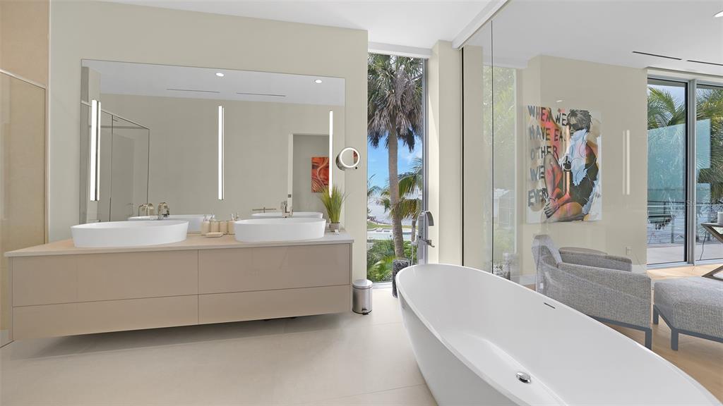 4123 Bay Shore Road Sarasota, FL 34234 - Photo 20 of 29 a bathroom with a tub a sink and a large mirror