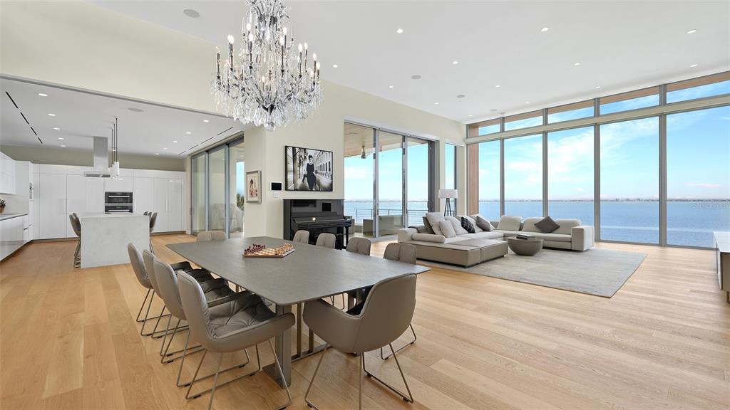 4123 Bay Shore Road Sarasota, FL 34234 - Photo 5 of 29 a view of a dining room with furniture a chandelier and large windows