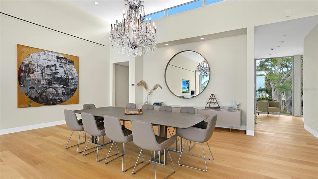 4123 Bay Shore Road Sarasota, FL 34234 - Photo 7 of 29 a view of a dining room with furniture a chandelier and wooden floor