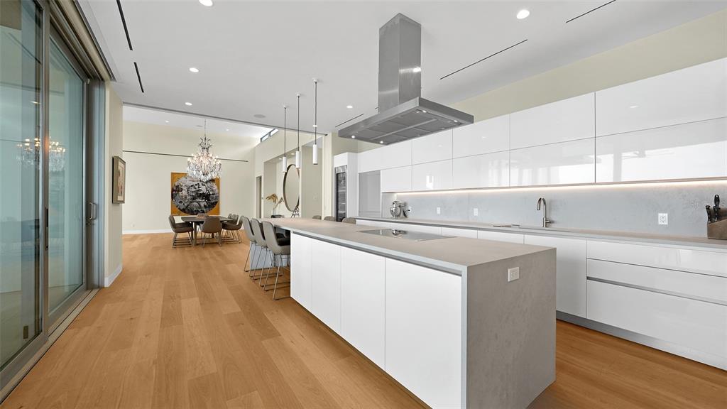 4123 Bay Shore Road Sarasota, FL 34234 - Photo 9 of 29 a large kitchen with stainless steel appliances a lot of counter space and a chandelier