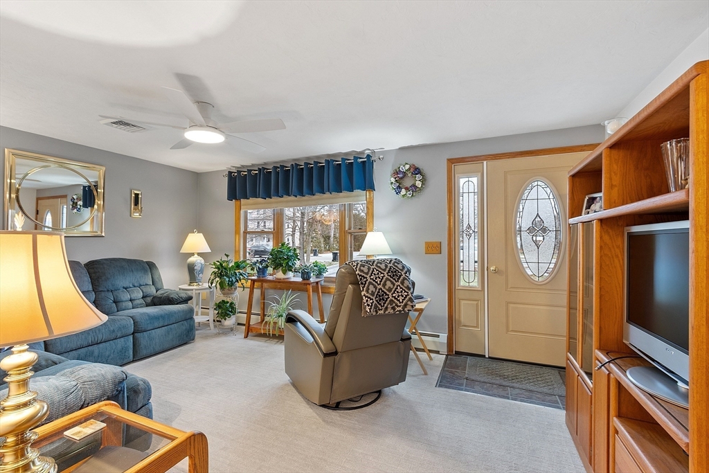 27 Lancaster Road Shirley, MA 01464 - Photo 13 of 41 a living room with furniture a window and a flat screen tv