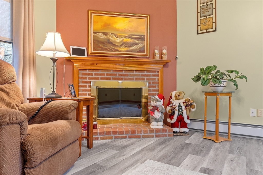 27 Lancaster Road Shirley, MA 01464 - Photo 14 of 41 a living room with furniture and a fireplace