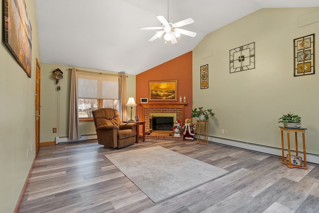 27 Lancaster Road Shirley, MA 01464 - Photo 15 of 41 a living room with furniture and a fireplace