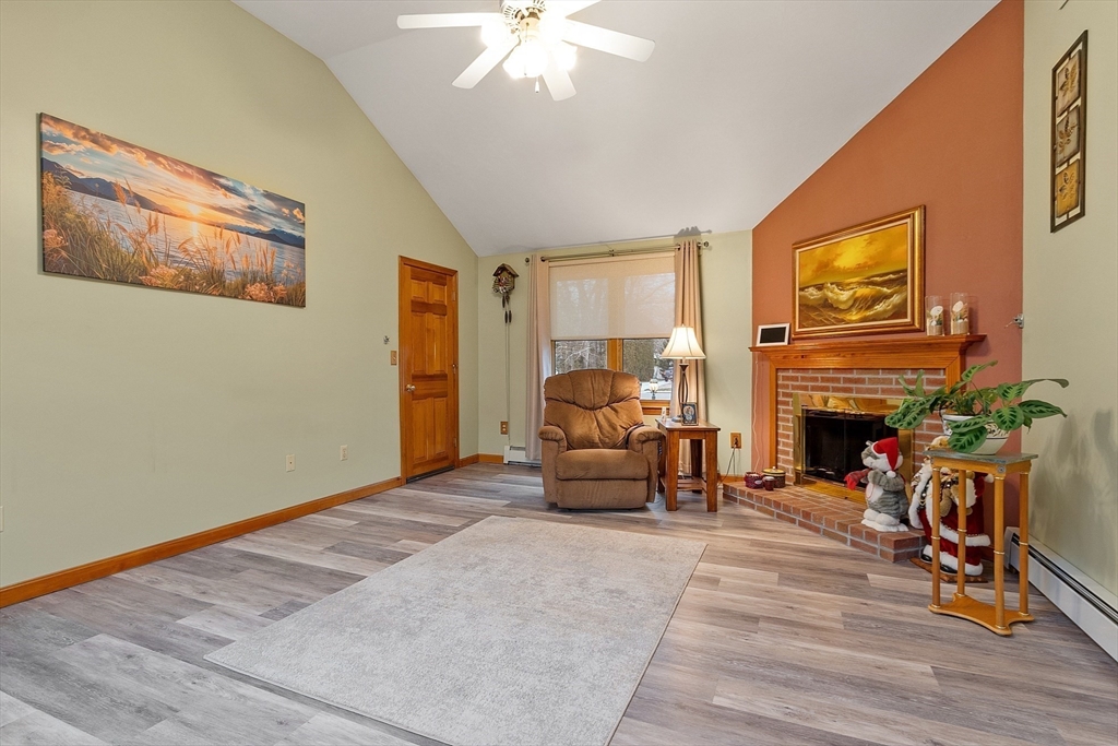 27 Lancaster Road Shirley, MA 01464 - Photo 16 of 41 a living room with furniture and a fireplace