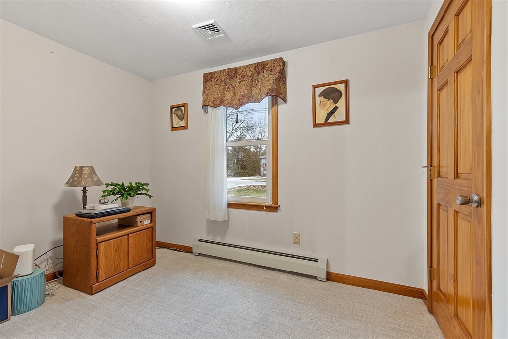 27 Lancaster Road Shirley, MA 01464 - Photo 20 of 41 a room with window and air conditioner vent