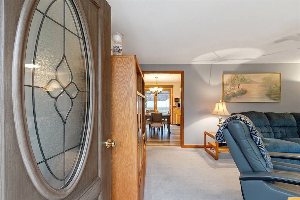 27 Lancaster Road Shirley, MA 01464 - Photo 24 of 41 a living room with furniture and a mirror