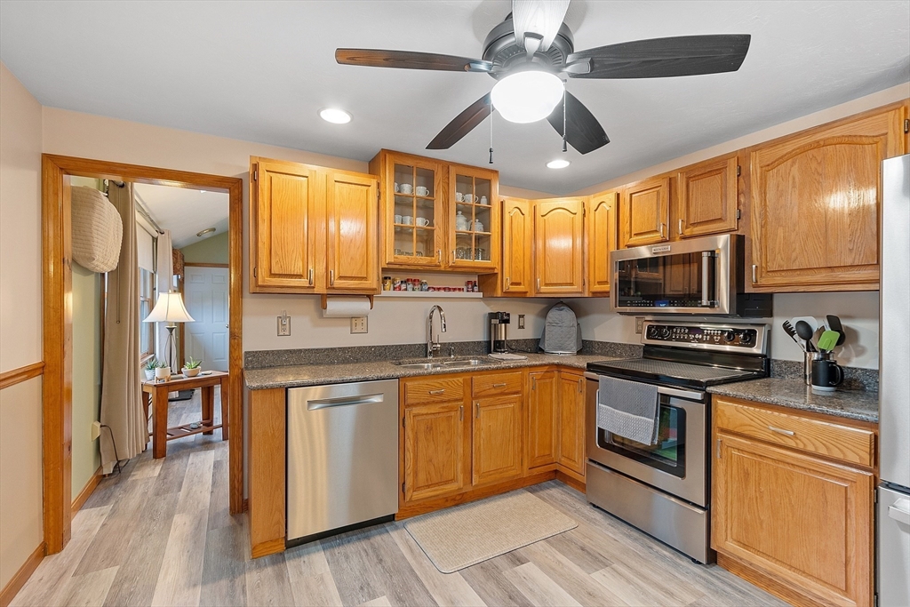 27 Lancaster Road Shirley, MA 01464 - Photo 5 of 41 a kitchen with stainless steel appliances granite countertop a stove and a sink