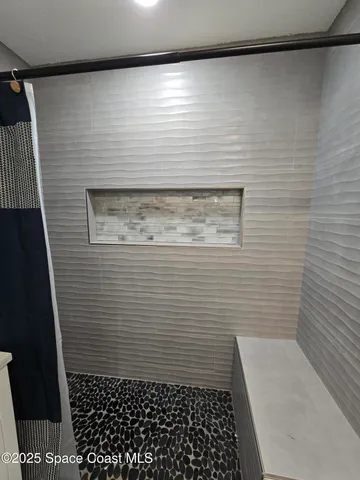 a bathroom with a double vanity sink toilet and mirror