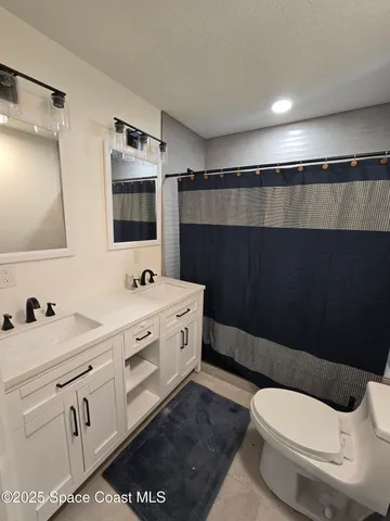 a large kitchen with stainless steel appliances kitchen island granite countertop a sink a stove top oven a counter space and cabinets