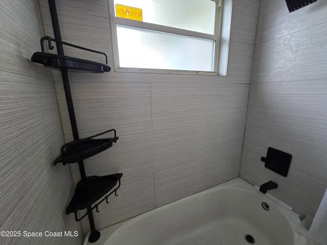 a bed room with a bed and a ceiling fan