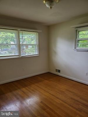 1501 Audmar Drive McLean, VA 22101 - Photo 18 of 24 an empty room with wooden floor and windows