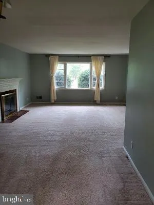 a view of empty room with a fireplace