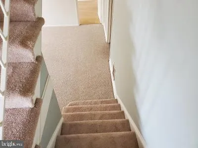 a view of staircase with white walls
