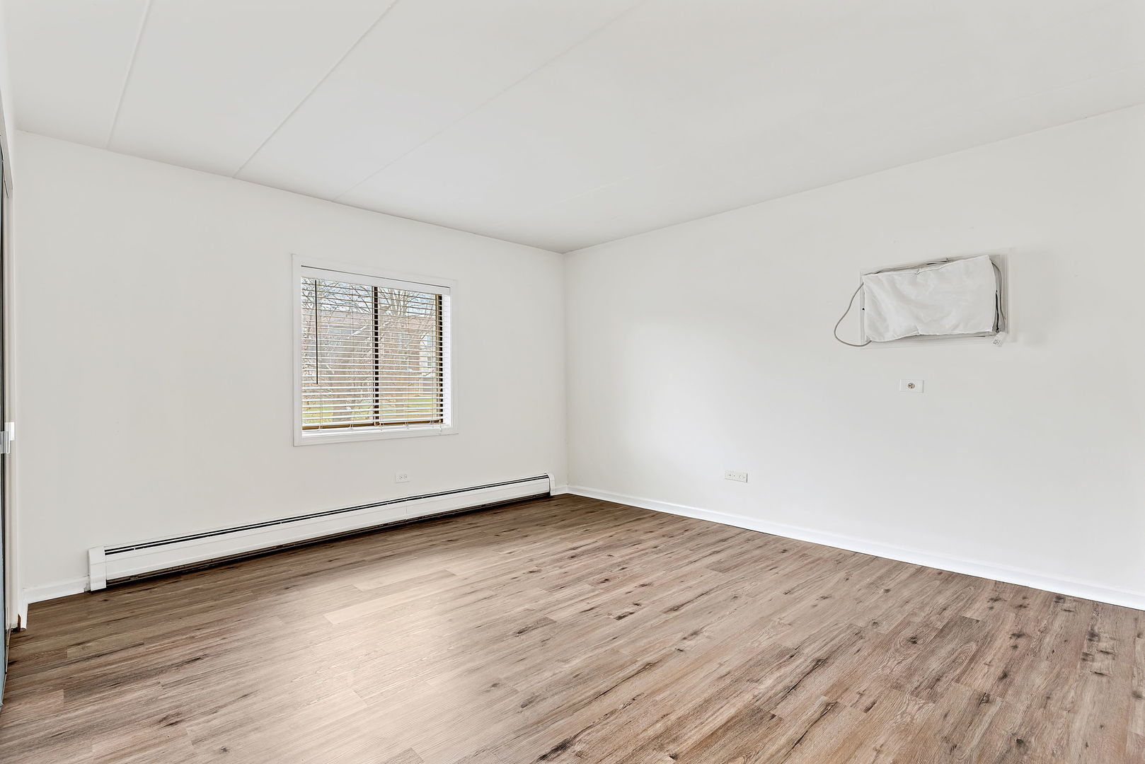 218 East Bailey Road, Unit E Naperville, IL 60565 - Photo 11 of 23 an empty room with wooden floor and windows