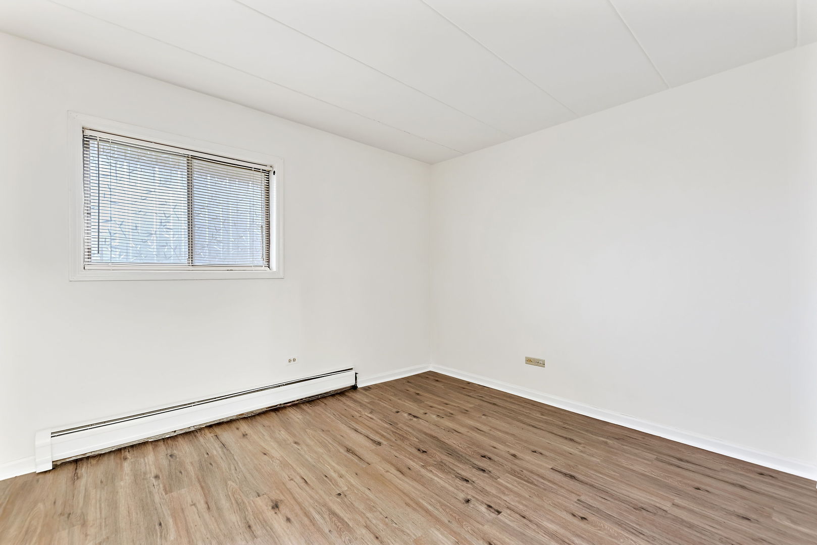 218 East Bailey Road, Unit E Naperville, IL 60565 - Photo 12 of 23 an empty room with wooden floor and windows