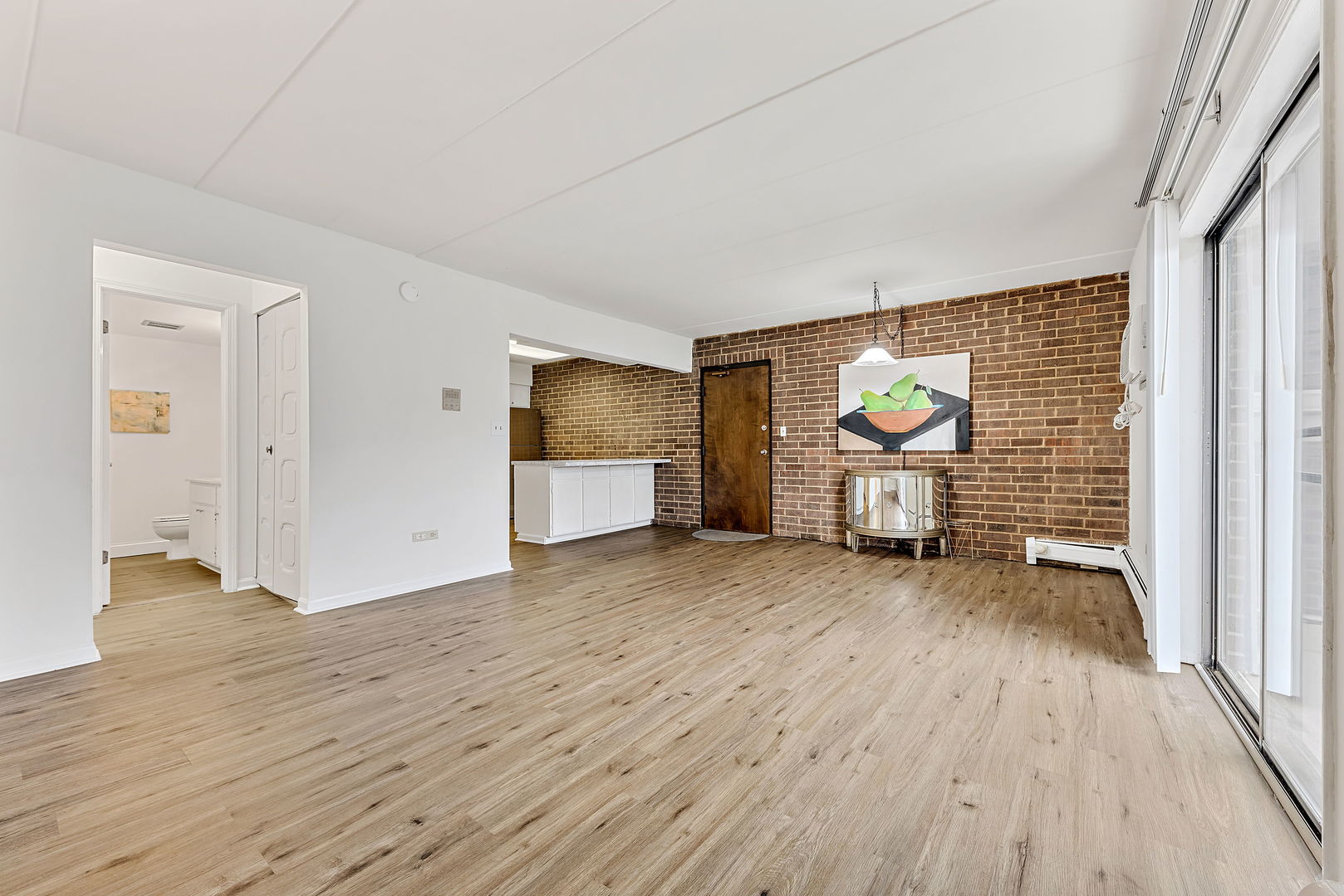 218 East Bailey Road, Unit E Naperville, IL 60565 - Photo 3 of 23 a view of empty room with wooden floor and fan