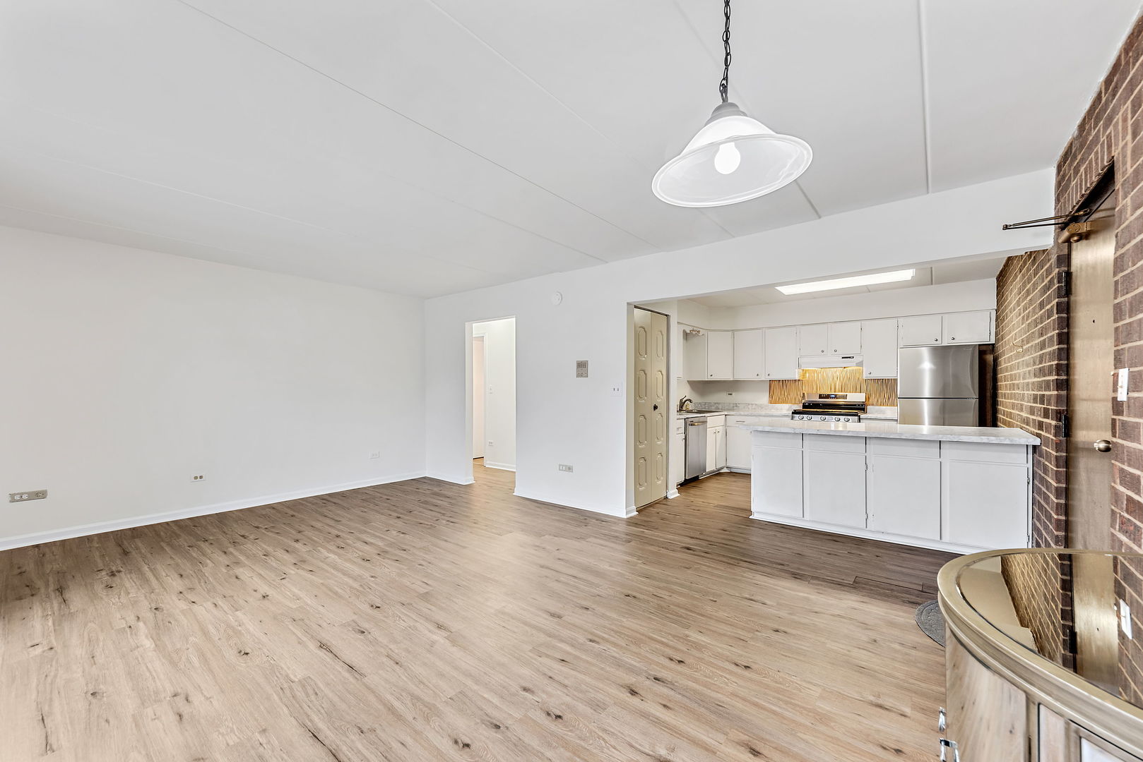 218 East Bailey Road, Unit E Naperville, IL 60565 - Photo 5 of 23 a view of open kitchen with wooden floor and stainless steel appliances