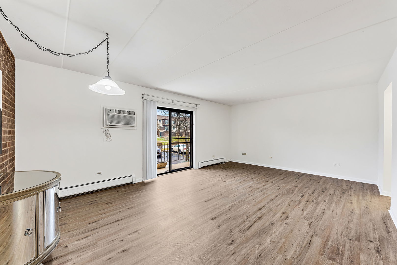 218 East Bailey Road, Unit E Naperville, IL 60565 - Photo 6 of 23 a view of an empty room with wooden floor and a window