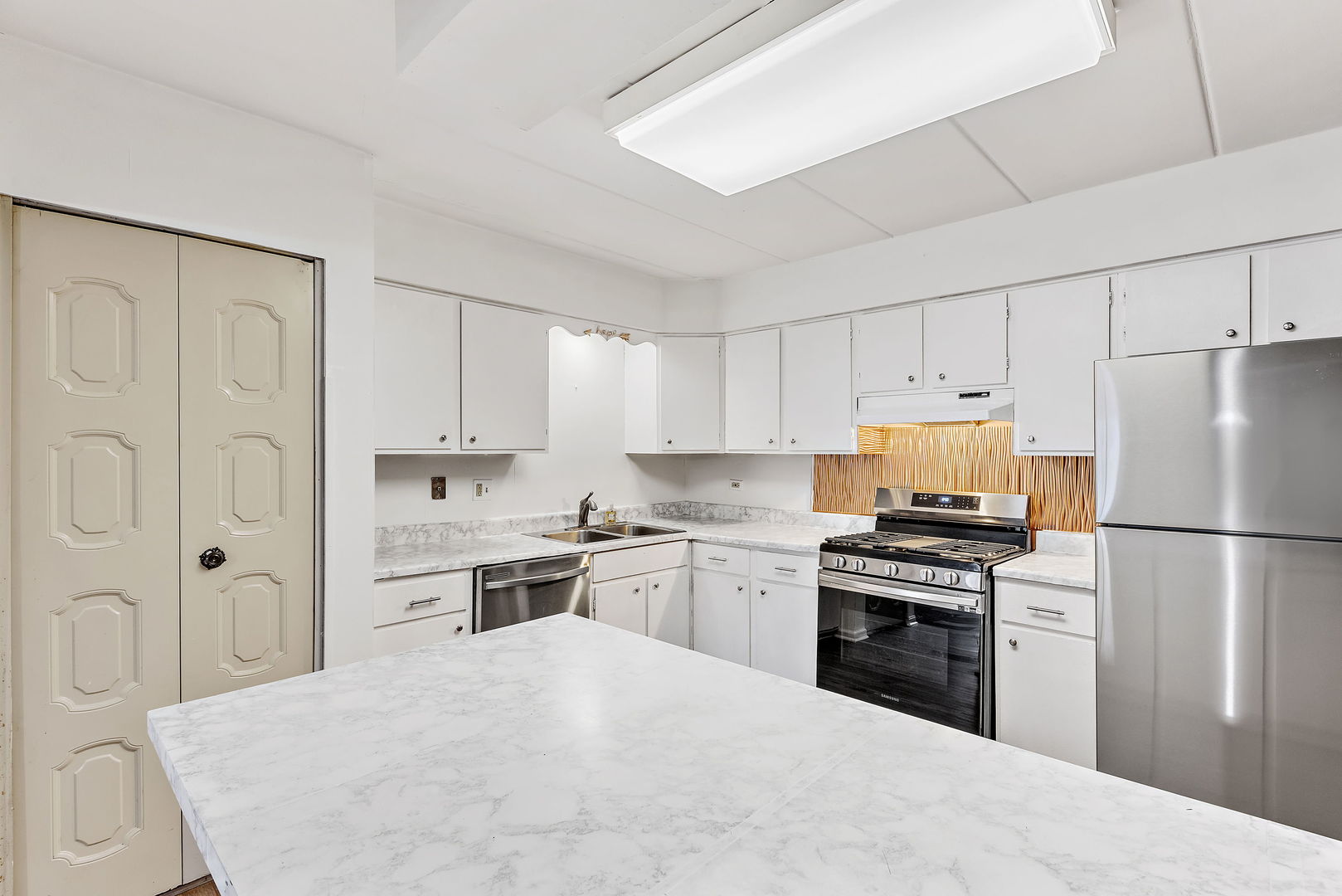 218 East Bailey Road, Unit E Naperville, IL 60565 - Photo 8 of 23 a kitchen with stainless steel appliances a refrigerator sink stove and white cabinets