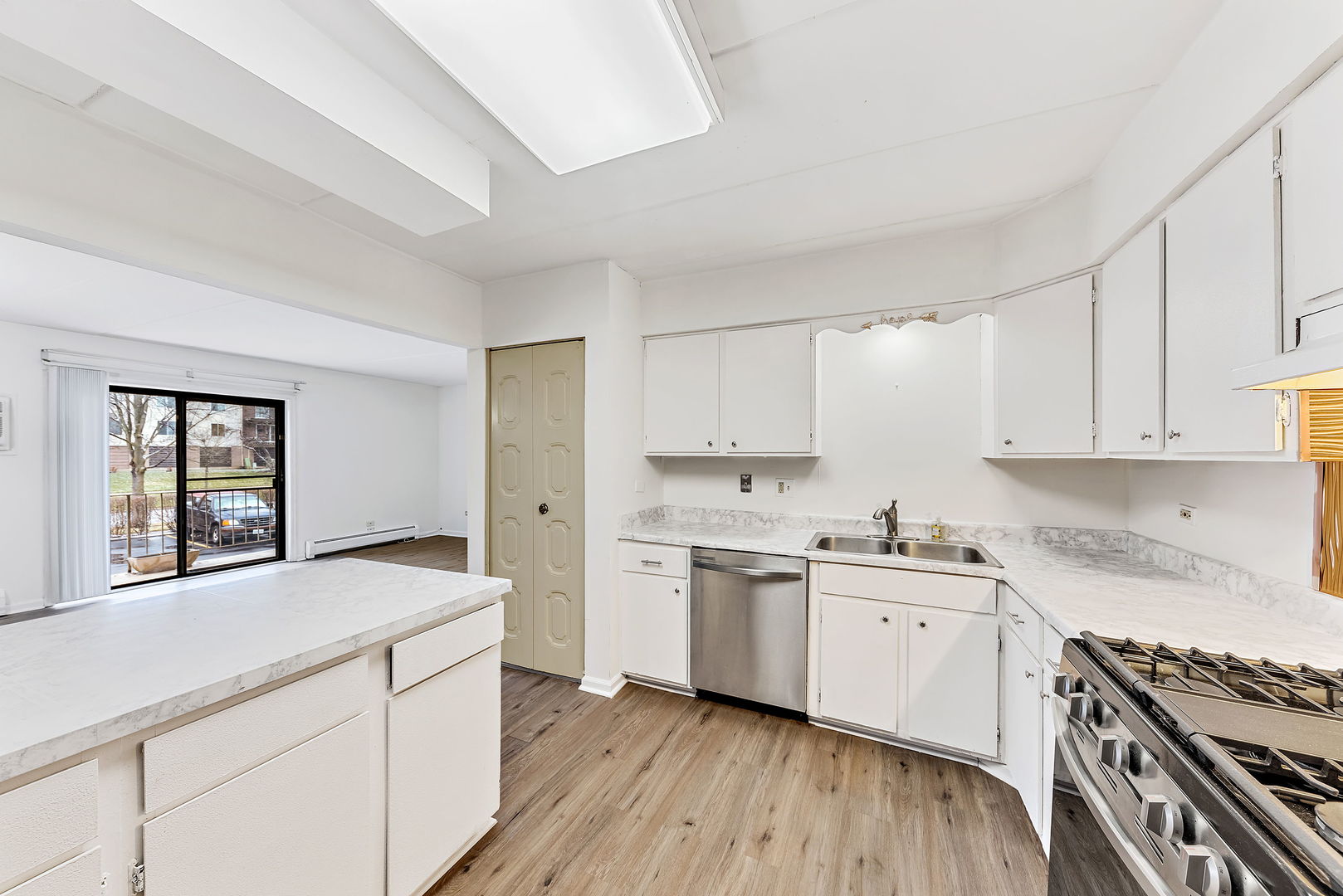 218 East Bailey Road, Unit E Naperville, IL 60565 - Photo 9 of 23 a kitchen with a sink stove and cabinets
