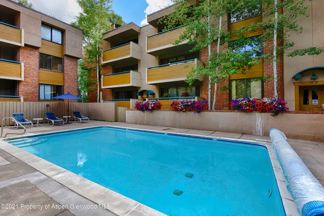 a view of a swimming pool with a lounge chair