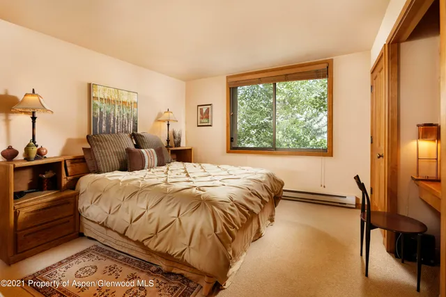 a bed sitting in a bedroom next to a window