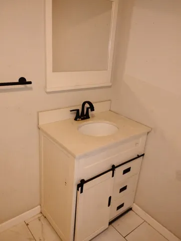 a bathroom with a sink and a mirror