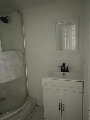 a bathroom with a sink a toilet and a shower