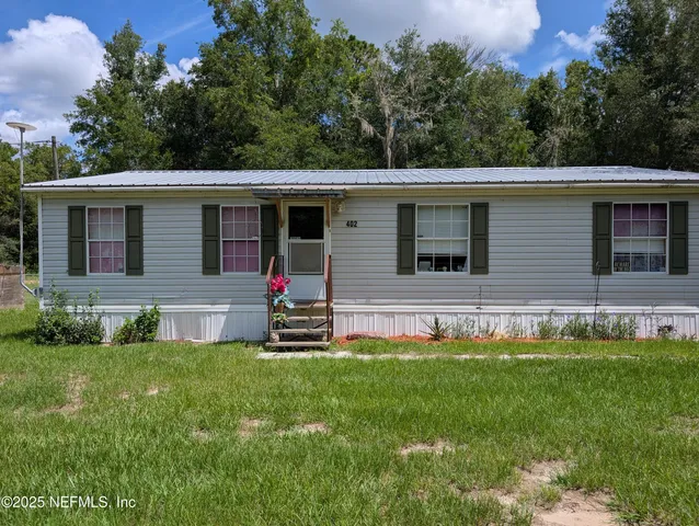 a house that has a big yard in front of it