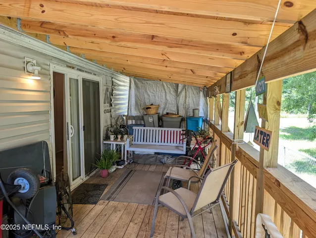 a view of balcony with wooden floor and outdoor seating