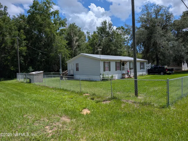 a view of a house with backyard and porch