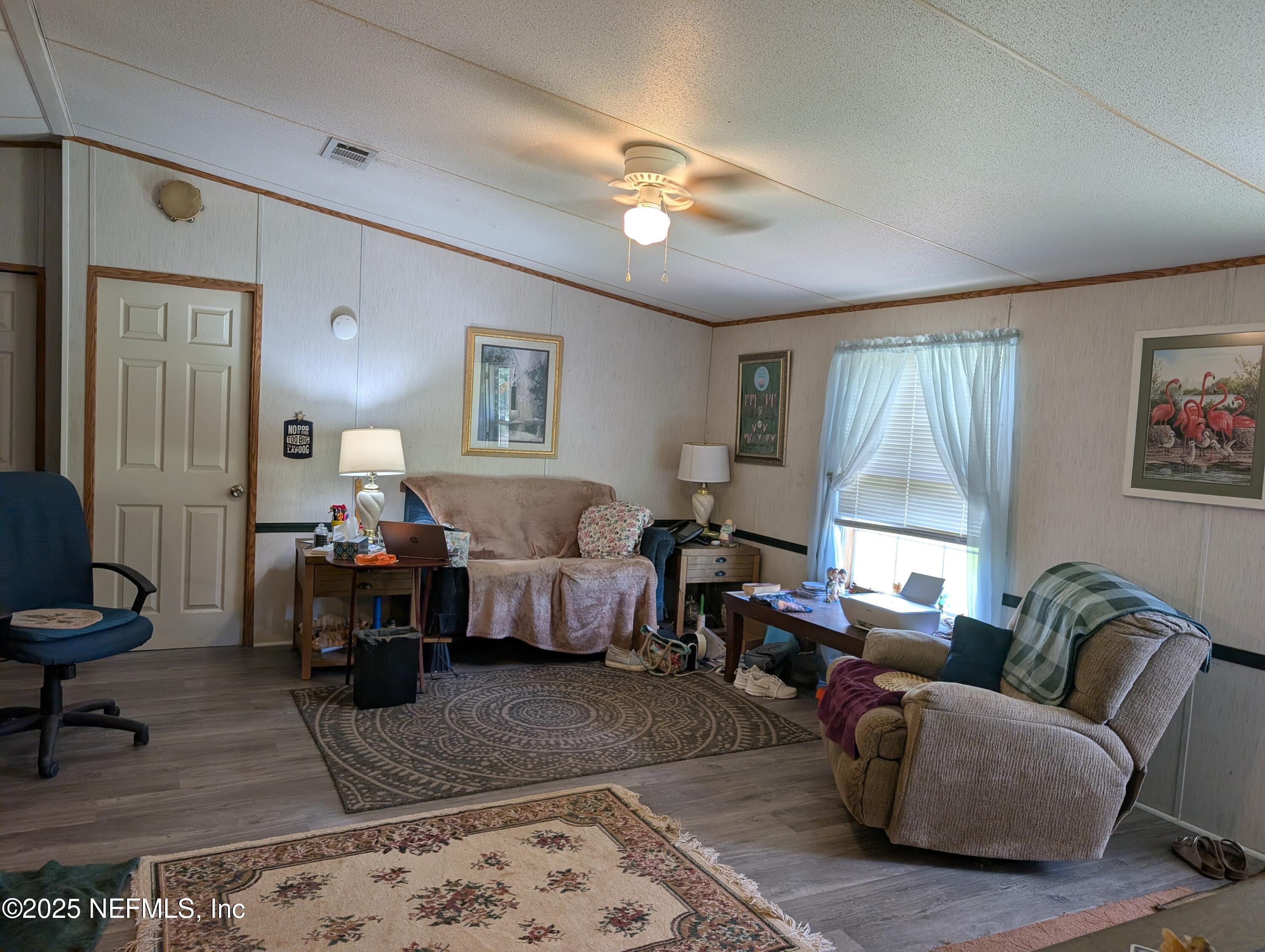 402 Shirley Street Interlachen, FL 32148 - Photo 5 of 20 a living room with furniture and a couch