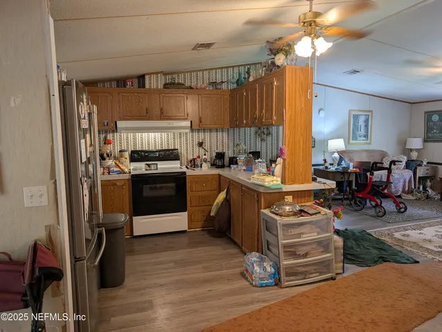 a kitchen with a stove a refrigerator and a dining table