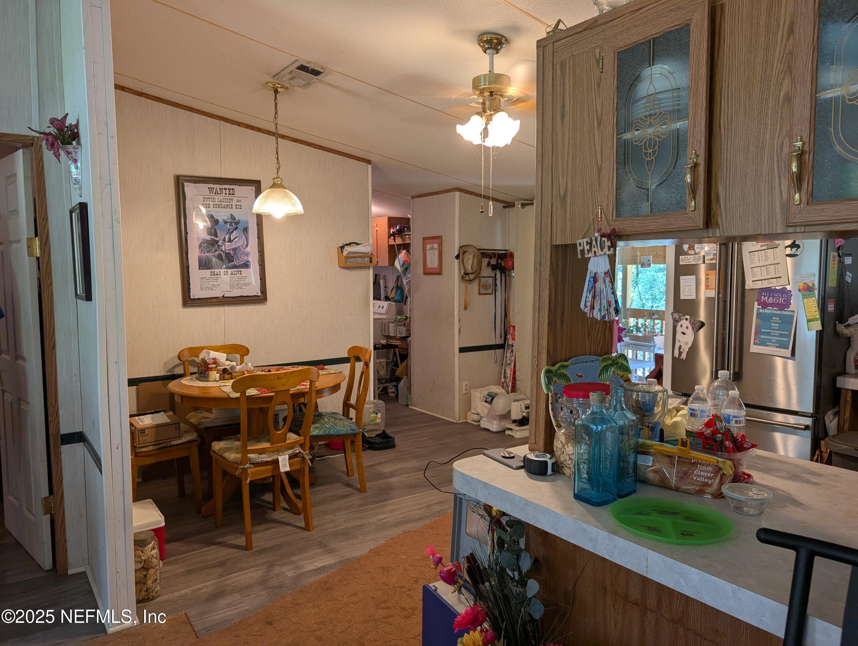 402 Shirley Street Interlachen, FL 32148 - Photo 8 of 20 a view of a dining room with furniture and chandelier
