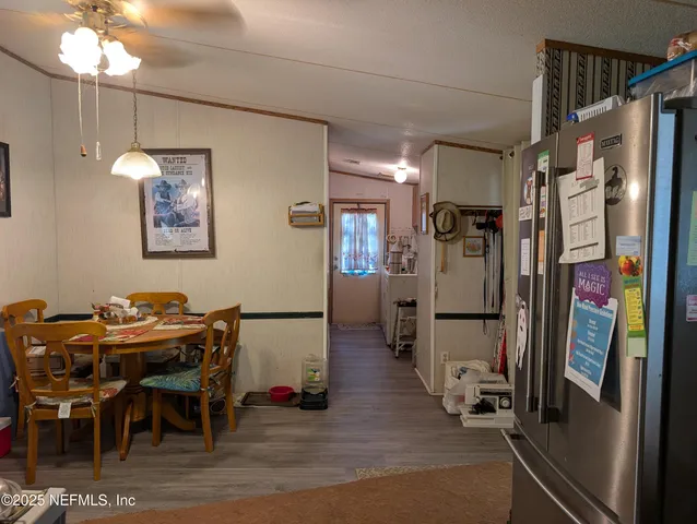a view of a dining room with furniture and a chandelier