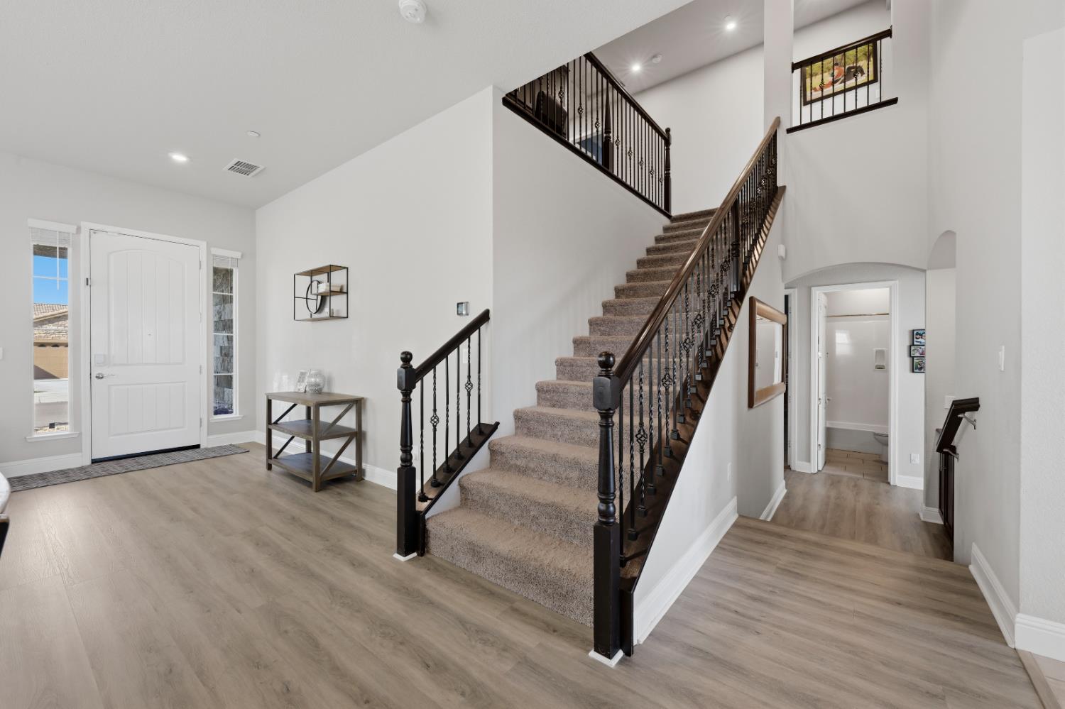 2012 Van Ruiten Drive Lodi, CA 95242 - Photo 8 of 49 a view of a hallway with wooden floor and stairs