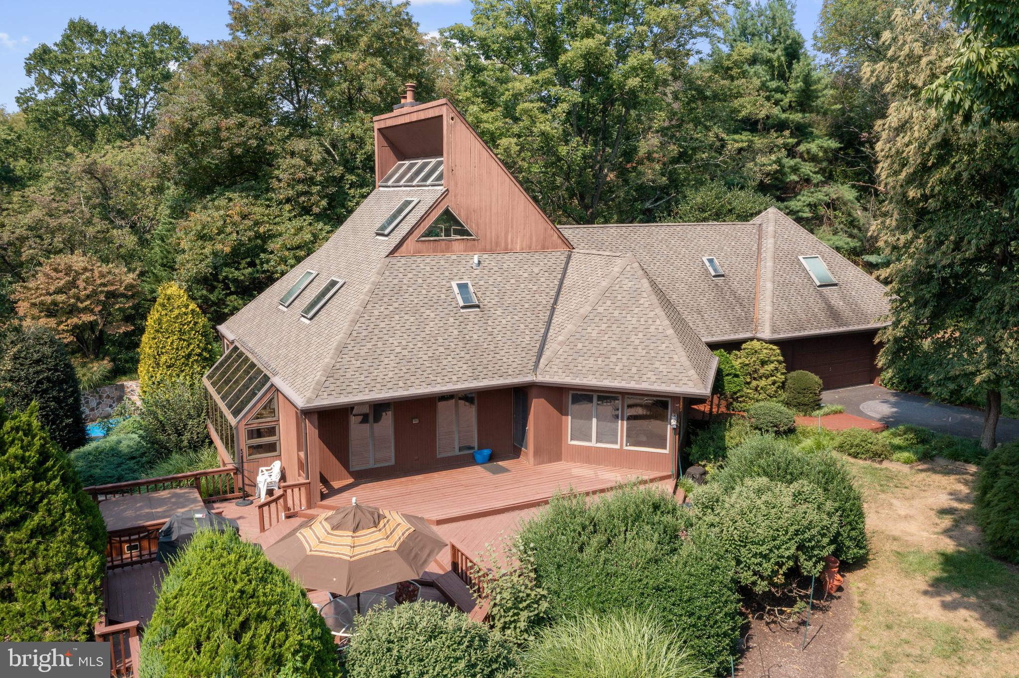 an aerial view of a house with a yard and balcony