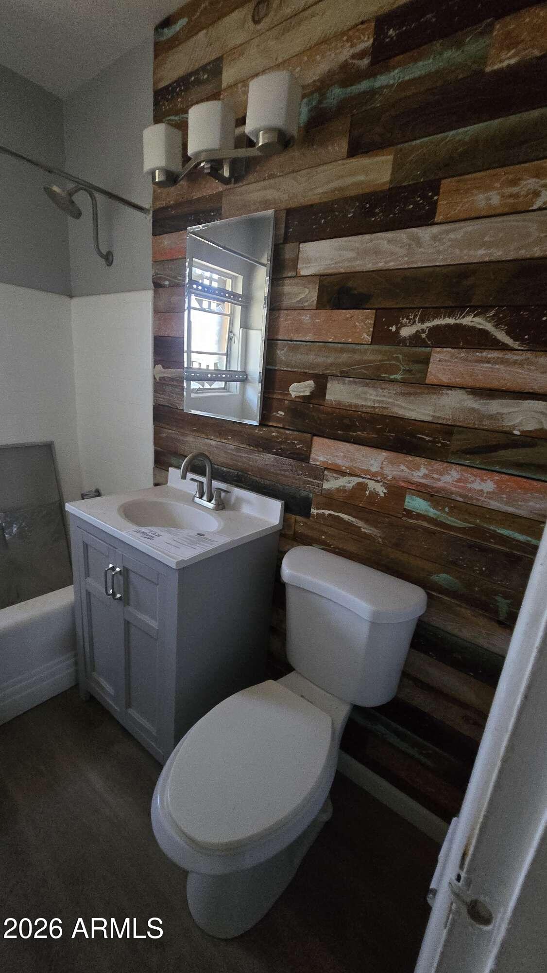 834 West Osborn Road Phoenix, AZ 85013 - Photo 21 of 45 a bathroom with a toilet a sink and a mirror