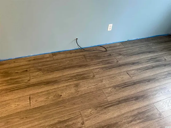 a view of a room with wooden floor