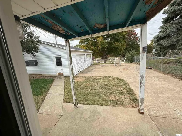 a view of backyard path and trees