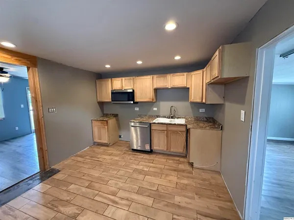 a kitchen with a refrigerator and a stove top oven