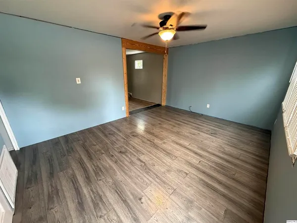 wooden floor in an empty room with a window