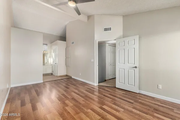a view of an empty room with wooden floor