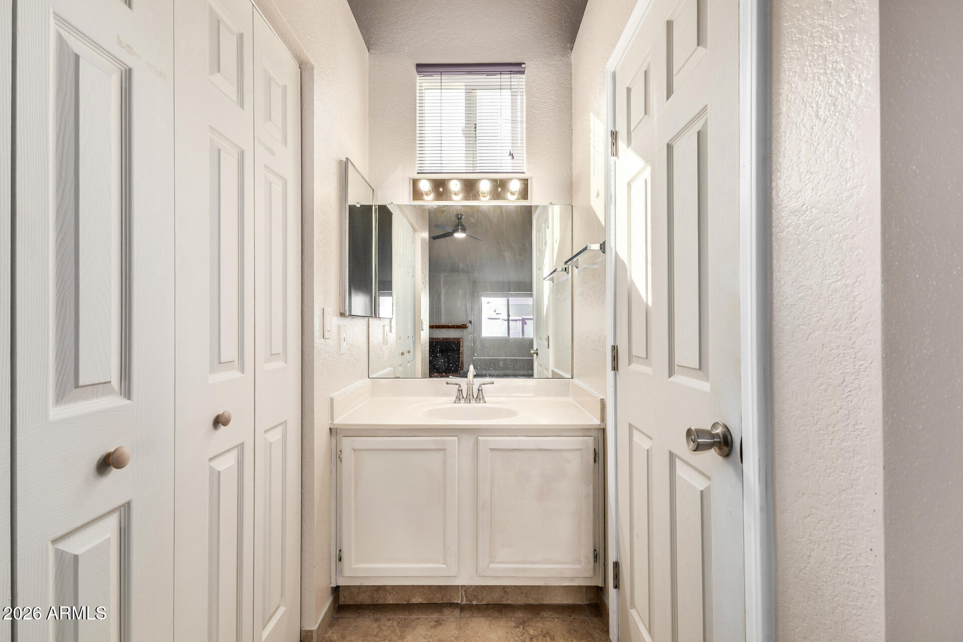 510 North Alma School Road, Unit 159 Mesa, AZ 85201 - Photo 12 of 31 a bathroom with a sink a mirror and a shower
