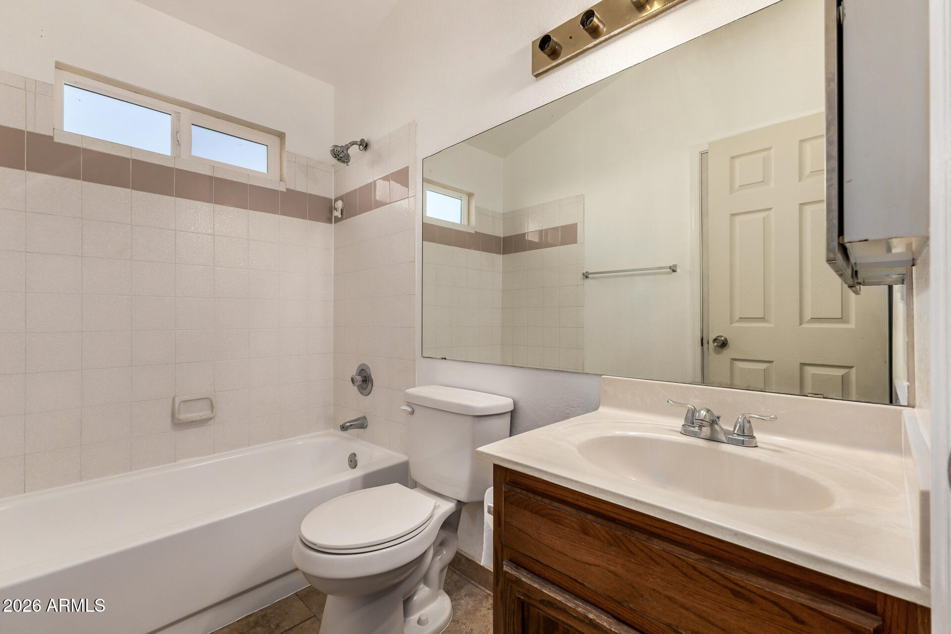 510 North Alma School Road, Unit 159 Mesa, AZ 85201 - Photo 17 of 31 a bathroom with a sink a toilet and a mirror