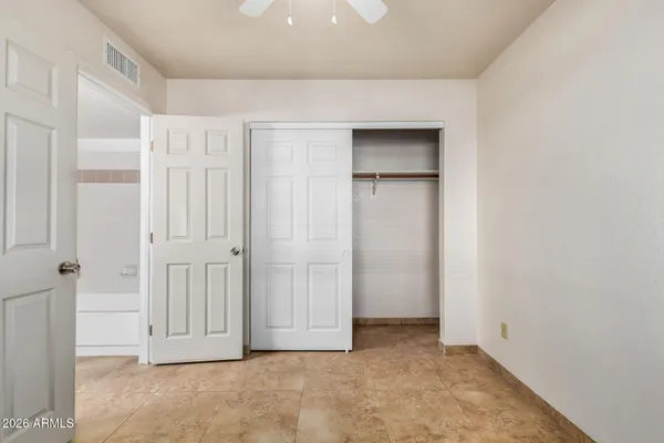 an empty room with closet area