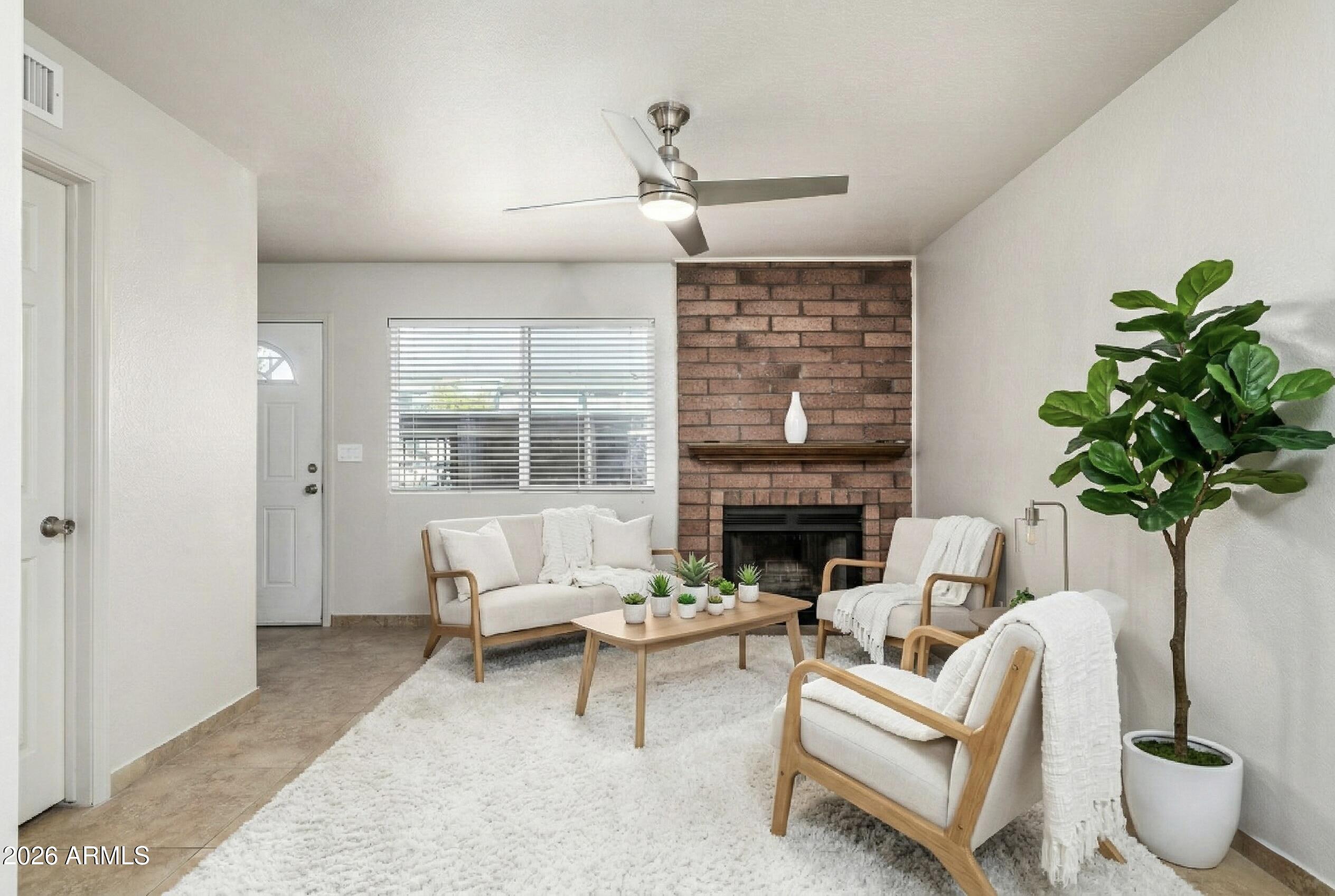 510 North Alma School Road, Unit 159 Mesa, AZ 85201 - Photo 2 of 31 a living room with furniture potted plant and a large window